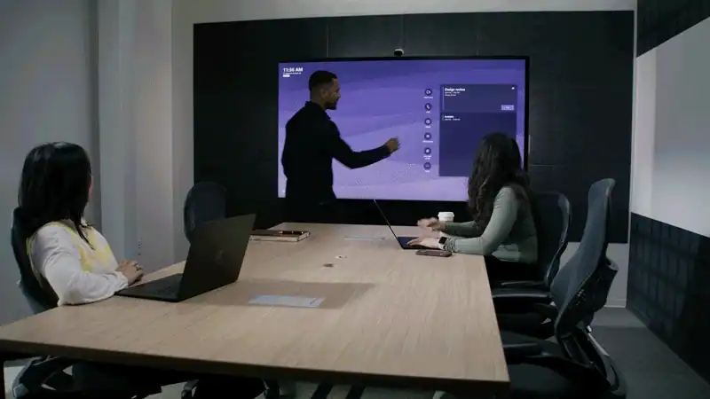 Modern presentation room with interactive display and meeting table